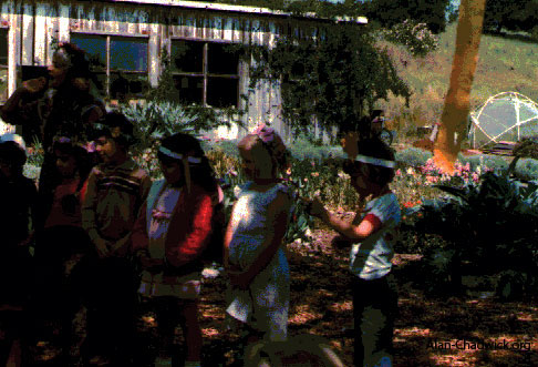 Young participants in the May Pole dance at the community garden.
